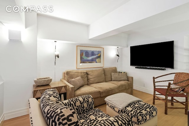 living room with baseboards and light wood-style floors