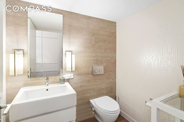 half bathroom featuring toilet and vanity
