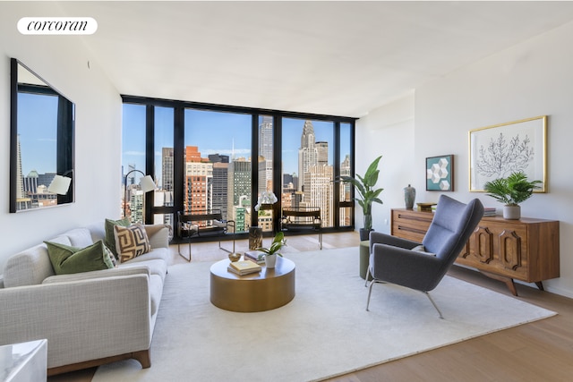 living room featuring expansive windows and light hardwood / wood-style floors