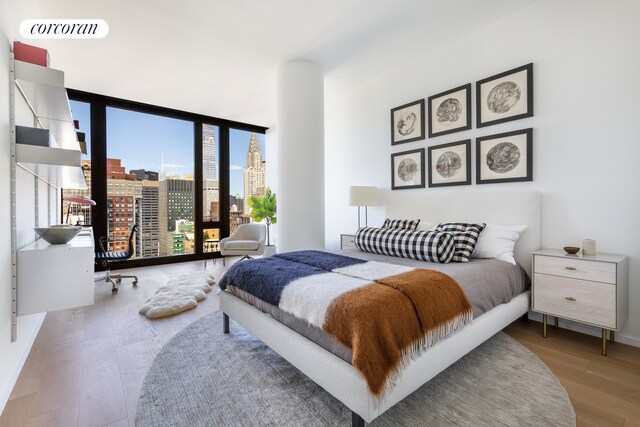 bedroom with hardwood / wood-style flooring and floor to ceiling windows