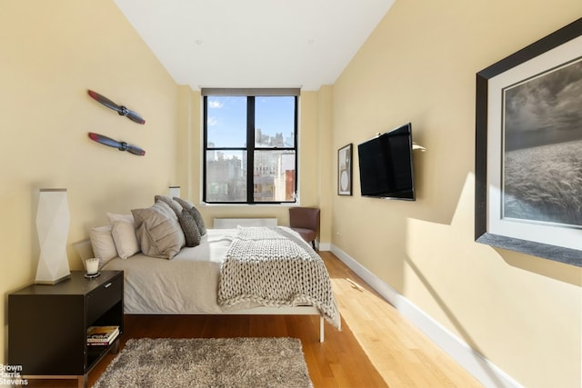 bedroom with hardwood / wood-style flooring