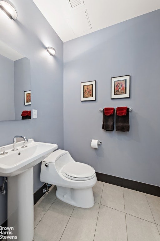 bathroom featuring toilet, tile patterned flooring, and sink