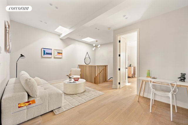 18 Orient Ave, New York City, NY 11211 - living area featuring a skylight, light wood-style floors, and baseboards