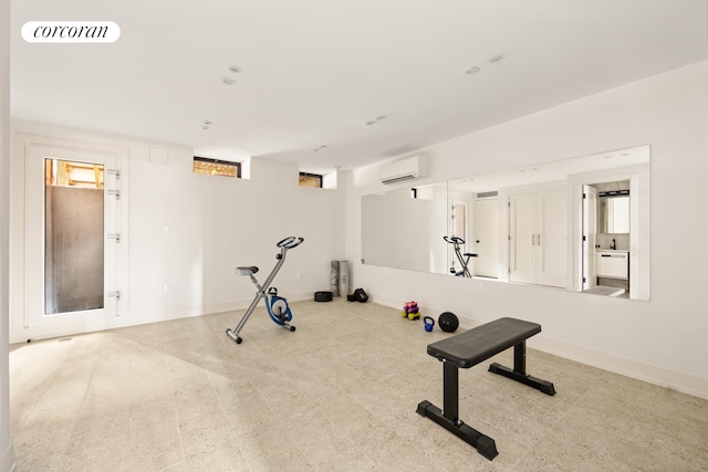 workout area featuring a wall unit AC, baseboards, and visible vents