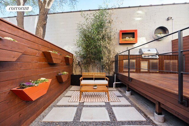 exterior space with grilling area, fence, and a deck