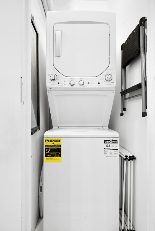 laundry room featuring stacked washer and dryer and laundry area