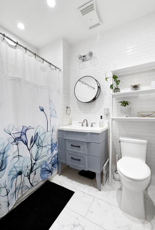 full bathroom with visible vents, a shower with shower curtain, toilet, marble finish floor, and vanity