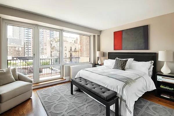 bedroom with wood finished floors and access to exterior
