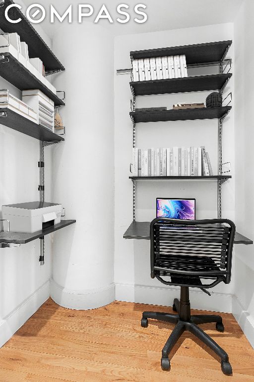 home office with hardwood / wood-style floors