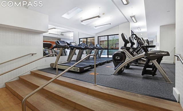 exercise room featuring lofted ceiling and wood-type flooring