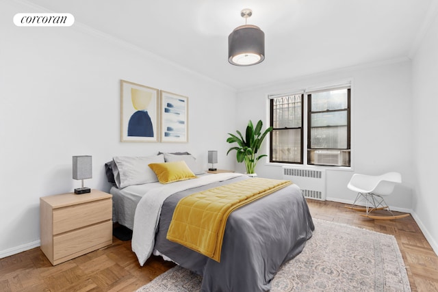 bedroom with parquet floors, crown molding, and radiator