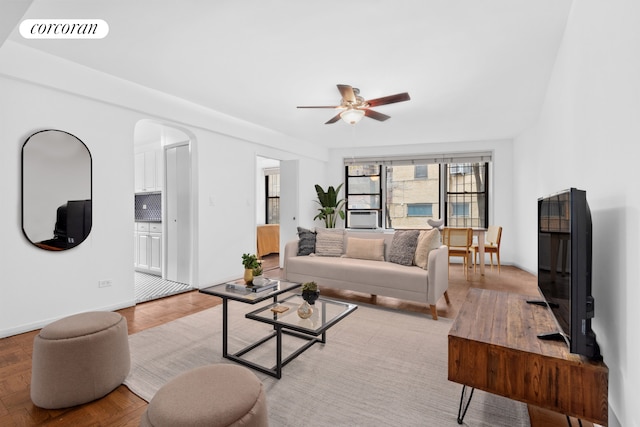 30 E 9th St Unit 1D, New York City, NY 10003 - living area featuring arched walkways, ceiling fan, visible vents, and baseboards