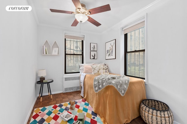 bedroom featuring dark parquet flooring, radiator, ceiling fan, and ornamental molding