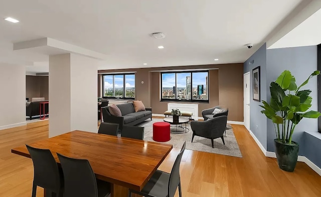 dining space with baseboards, recessed lighting, and light wood-style floors