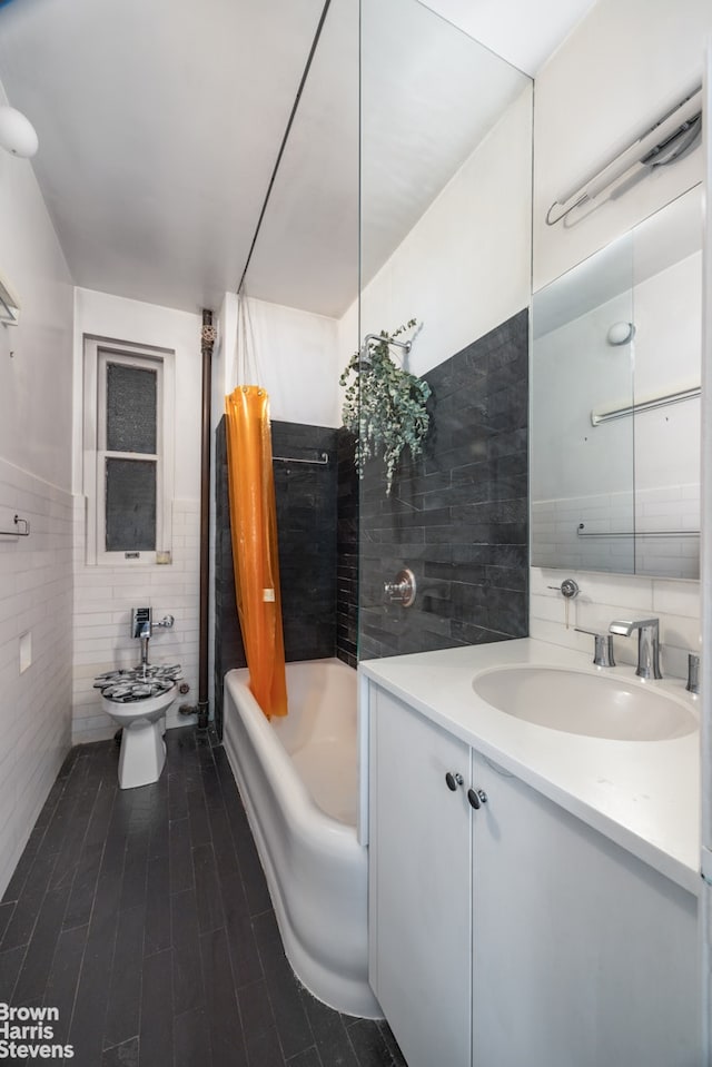 bathroom featuring tile walls, vanity, shower / tub combo, and wood finished floors