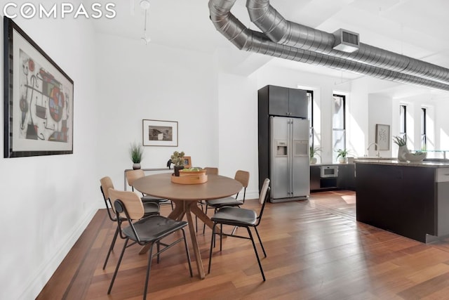 dining area featuring dark wood-type flooring