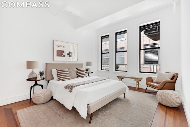 bedroom featuring hardwood / wood-style flooring and multiple windows