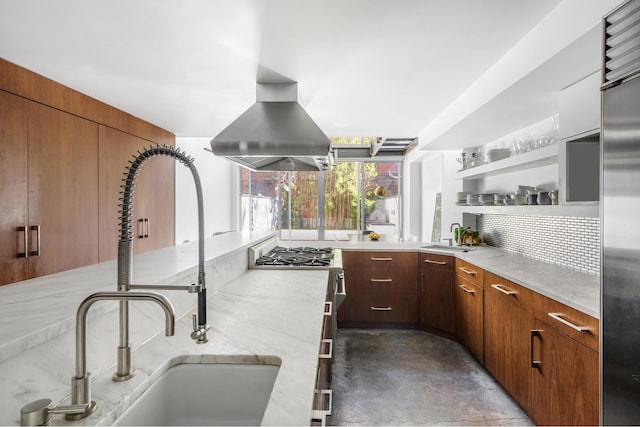 kitchen with tasteful backsplash, built in fridge, a sink, and island range hood