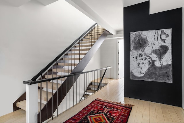 stairway featuring wood finished floors