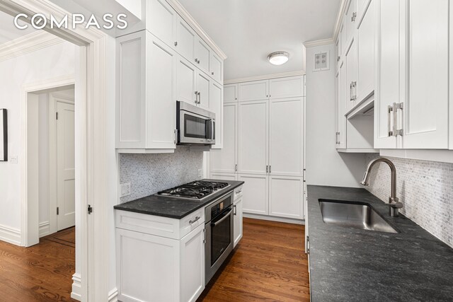 kitchen with white cabinets, stainless steel appliances, and a sink