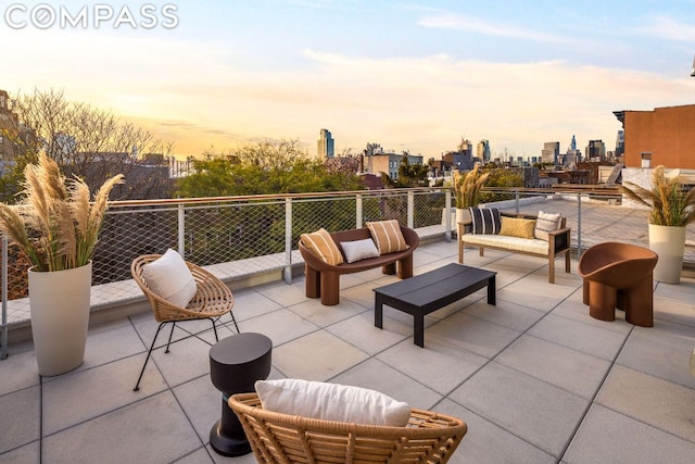 patio terrace at dusk featuring outdoor lounge area