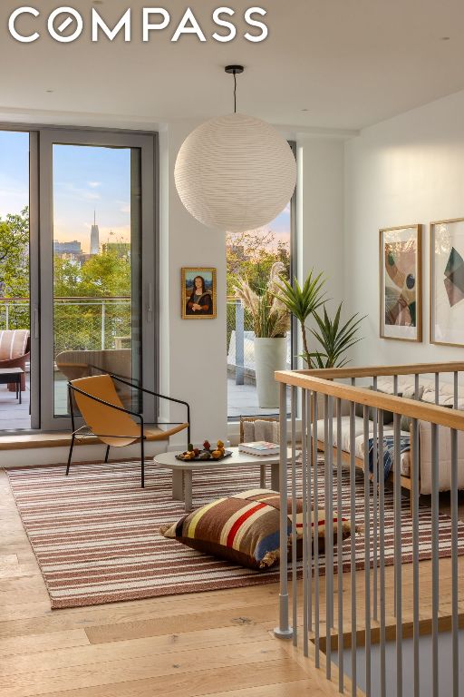 sitting room with a healthy amount of sunlight and hardwood / wood-style flooring