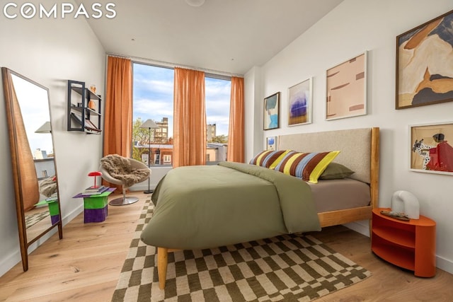 bedroom featuring floor to ceiling windows and light hardwood / wood-style flooring