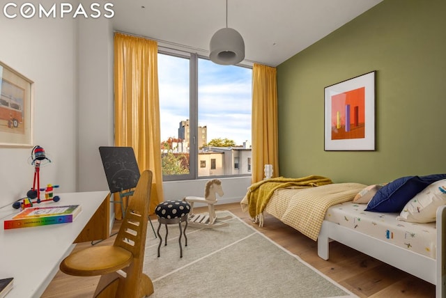 bedroom featuring light wood-type flooring and multiple windows