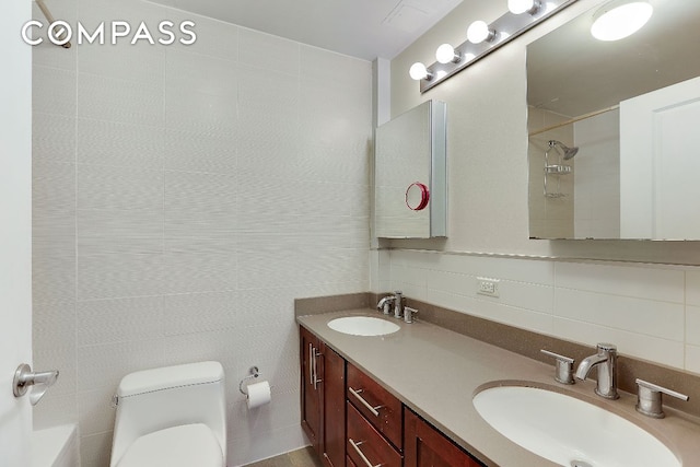 full bathroom featuring shower / bath combination, tile walls, vanity, decorative backsplash, and toilet