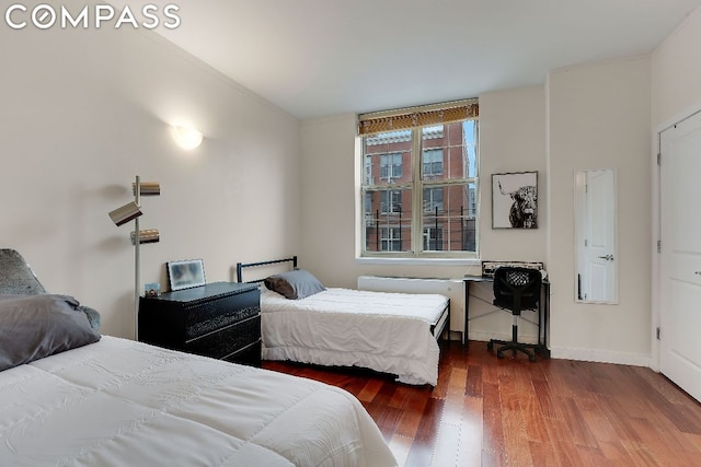 bedroom with dark hardwood / wood-style floors