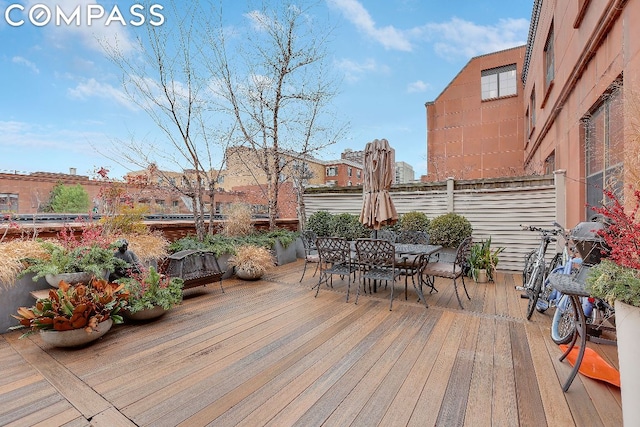 wooden terrace featuring outdoor dining space