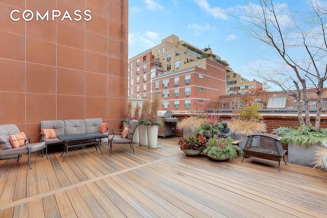 wooden deck featuring grilling area and an outdoor living space