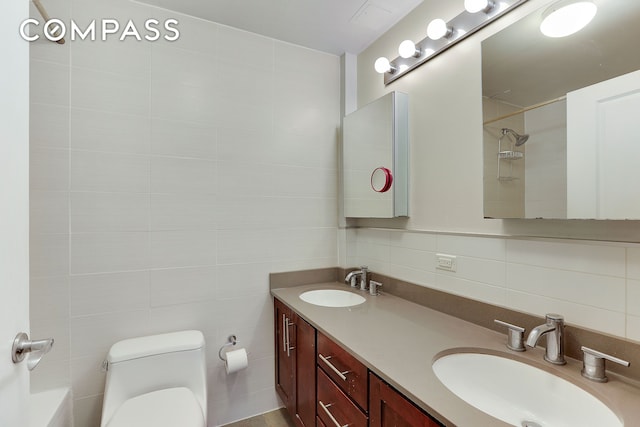 full bath with toilet, tile walls, decorative backsplash, and a sink