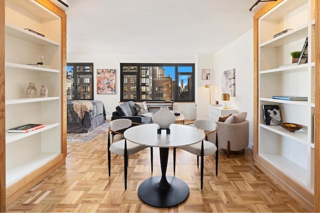 dining area featuring built in features and light parquet floors