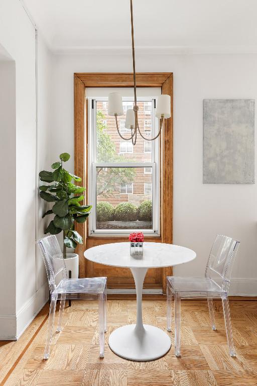 dining space featuring light parquet floors and a chandelier