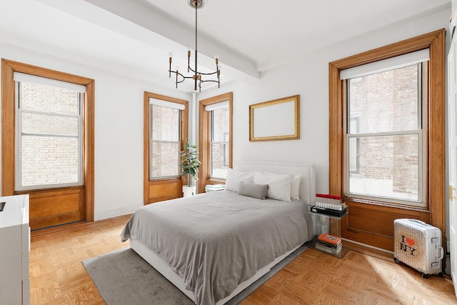 bedroom with a chandelier and light parquet flooring