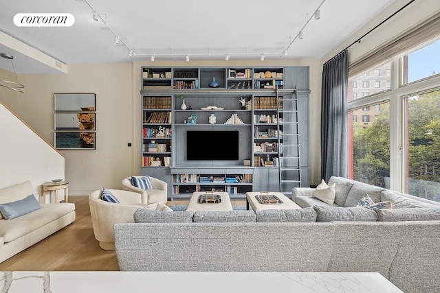 living area featuring visible vents and wood finished floors