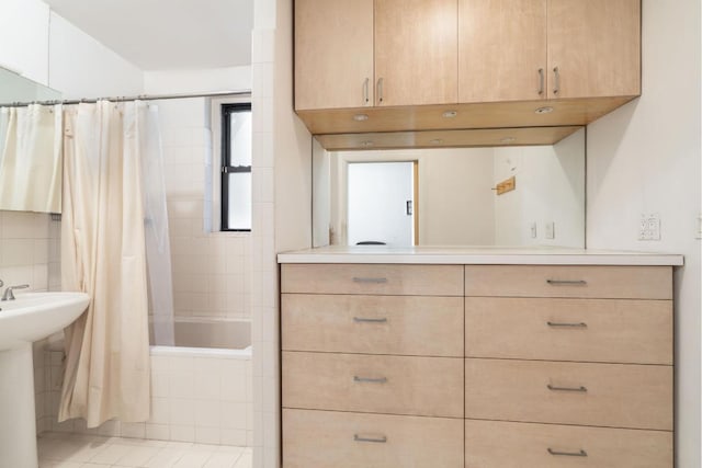 bathroom featuring sink and shower / bathtub combination with curtain