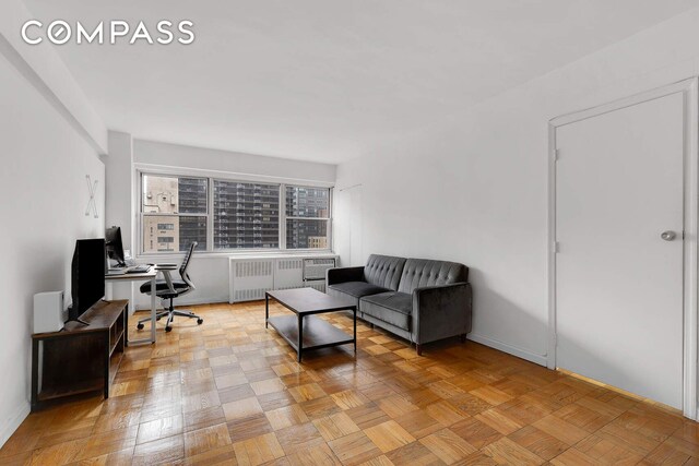 living room with radiator and light parquet floors