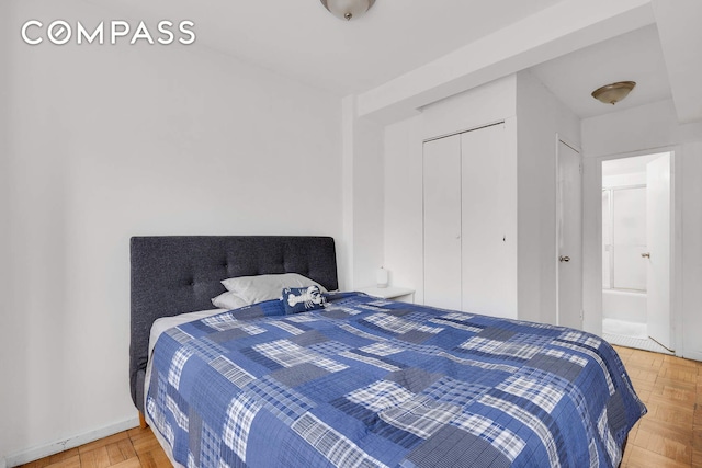 bedroom featuring ensuite bathroom and a closet