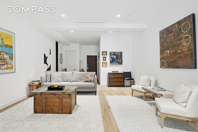 living area with recessed lighting, light wood-style flooring, and baseboards