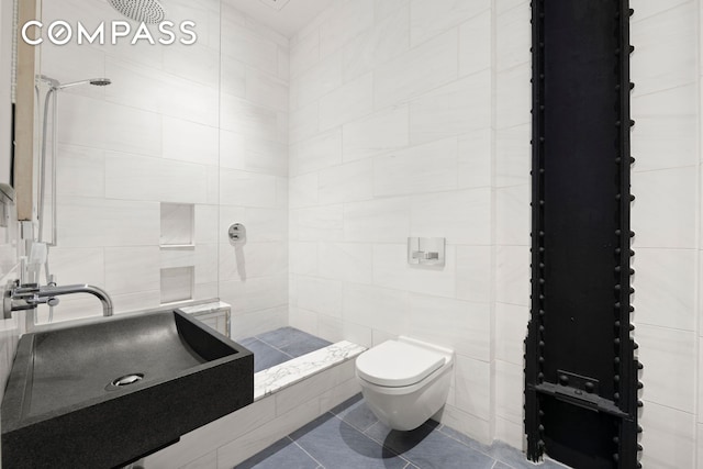 181 Hudson St Unit 2B, New York City, NY 10013 - full bathroom with a tile shower, tile patterned floors, and tile walls