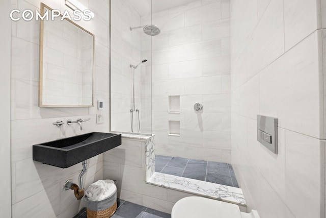 181 Hudson St Unit 2B, New York City, NY 10013 - bathroom featuring a tile shower and tile walls