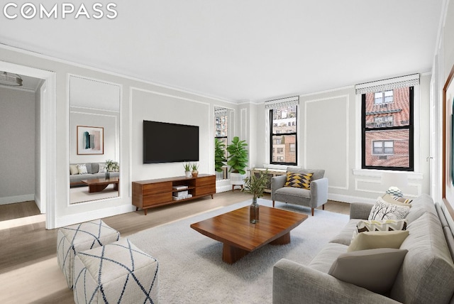 living room featuring ornamental molding and light wood-type flooring