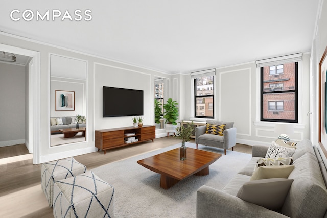 321 E 54th St Unit 10B, New York City, NY 10022 - living room featuring ornamental molding, wood finished floors, and a decorative wall