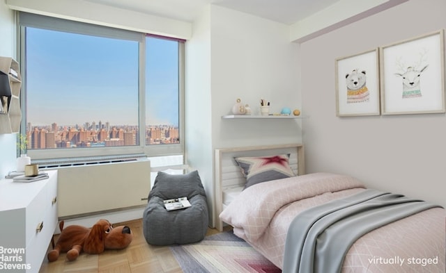 bedroom with a city view and multiple windows