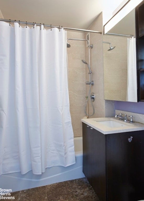 full bathroom featuring vanity and shower / bathtub combination with curtain