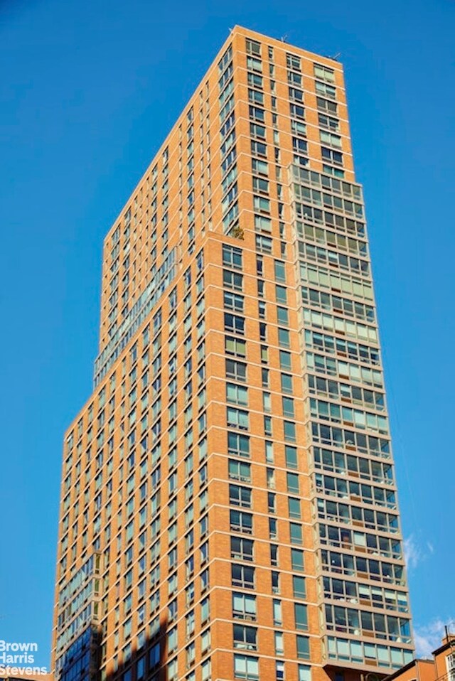 215 E 96th St Unit 25C, New York City, NY 10128 - view of building exterior with a cooling unit