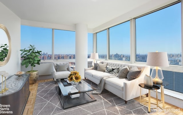 sunroom featuring a wealth of natural light and a city view