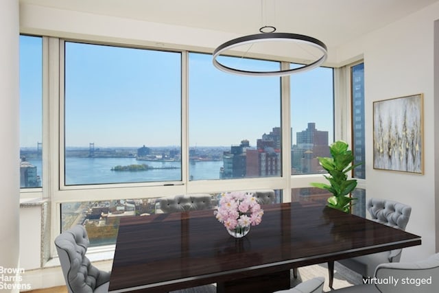 dining area with a view of city and a water view